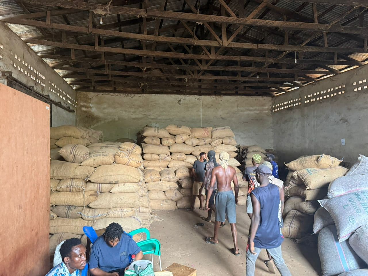 Bagged cocoa beans stacked inside an NT COCO warehouse